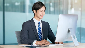  オフィスでパソコンに向かう男性社員